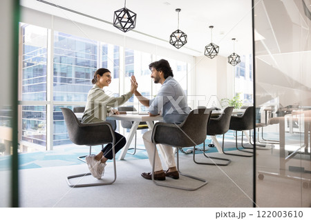 Happy Indian coworkers celebrating business success, successful cooperation 122003610