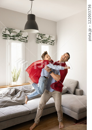 Cheerful carefree dad lifting kid, holding child in arms Cheerful carefree dad lifting kid, holding child in arms 122003736