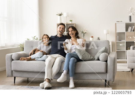 Family members, laughing, watching comedy movie or educational program Family members, laughing, watching comedy movie or educational program 122003793
