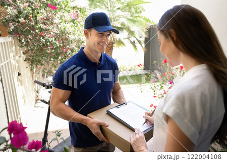 Customer woman signing receiving confirmation document for courier 122004108