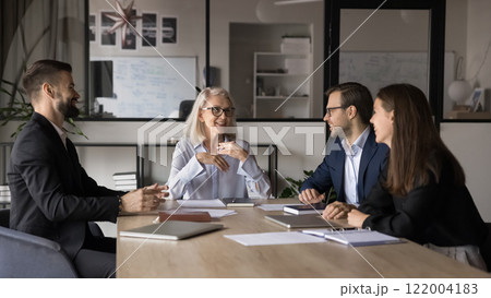 Employees listening mature leader, discussing strategy, making speech at briefing 122004183