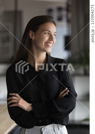 Vertical portrait of dreamy businesswoman looking aside with smile Vertical portrait of dreamy businesswoman looking aside with smile 122004273