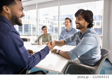 Happy confident diverse business colleagues shaking hands Happy confident diverse business colleagues shaking hands 122004315