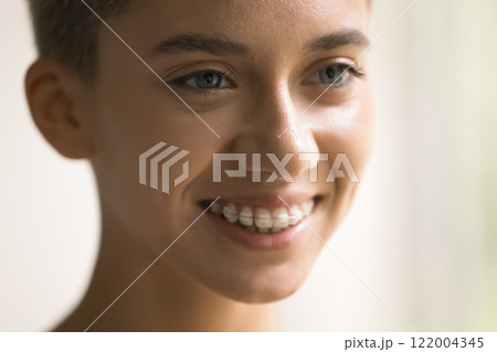 Close up cropped shot beautiful smiling millennial European female face 122004345