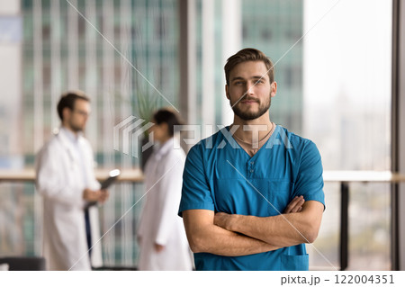 Hospital employee wear blue uniform scrubs posing in office 122004351