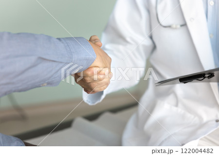 Cropped shot of male doctor and patient shaking hands 122004482