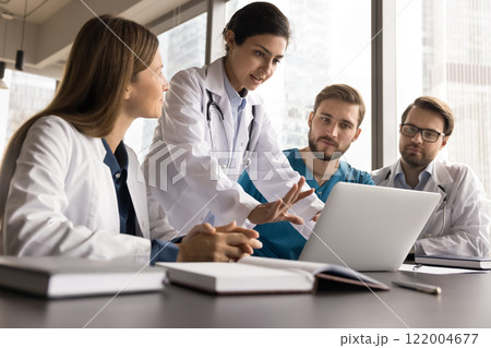 Group of skilled medical workers in uniforms engaged in teamwork Group of skilled medical workers in uniforms engaged in teamwork 122004677