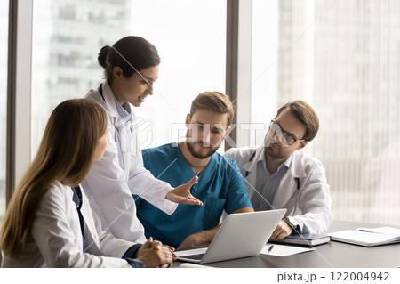 Group of multinational doctors gathers together to discuss patient case 122004942