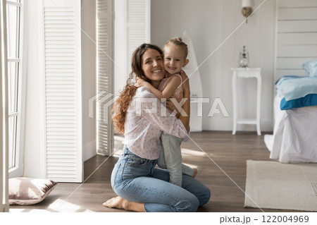 Portrait happy young mother holding preschool daughter child in arms 122004969