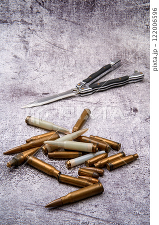Different types of ammunition scattered on the ground. Different types of ammunition scattered on the ground. 122006596