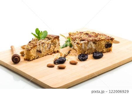 Ruddy sponge cake with prunes and nuts for tea, isolated on white background 122006929