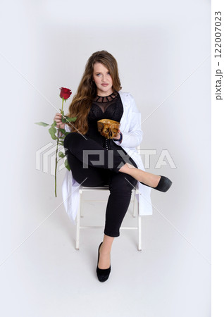 Elegance, celebration and party concept. Attractive young happy woman having birthday, receiving gifts, beautiful flowers, holding roses and champagne glass 122007023
