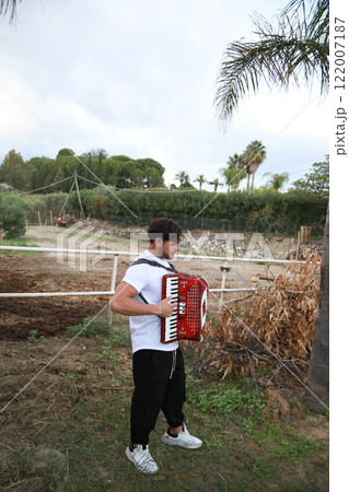 Music Sounds From Accordion In The Green Field 122007187