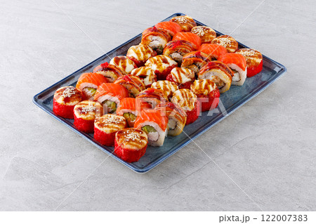 Japanese sushi rolls, sushi sets on a gray background for restaurant menu and food delivery Japanese sushi rolls, sushi sets on a gray background for restaurant menu and food delivery 122007383