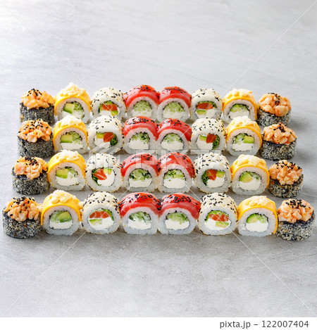 Japanese sushi rolls, sushi sets on a gray background for restaurant menu and food delivery Japanese sushi rolls, sushi sets on a gray background for restaurant menu and food delivery 122007404