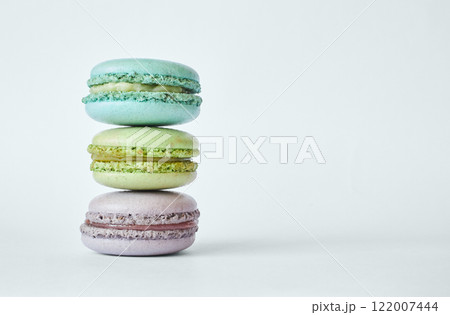 Stack of three colorful French Macarons, macaroons cakes with different flavors Stack of three colorful French Macarons, macaroons cakes with different flavors 122007444