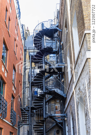 Outdoor Emergency Spiral Staircase Winding Between Urban Architecture 122007722