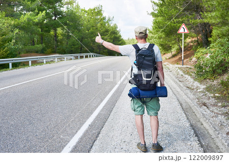 Tourist traveler is on roadside 122009897