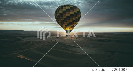 Hot Air Balloon Flying Over Deserted Sand Dunes at Sunrise 122010079