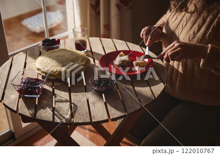 Woman Enjoying Crepes with Berry Jelly on Pancake Day at Home Woman Enjoying Crepes with Berry Jelly on Pancake Day at Home 122010767