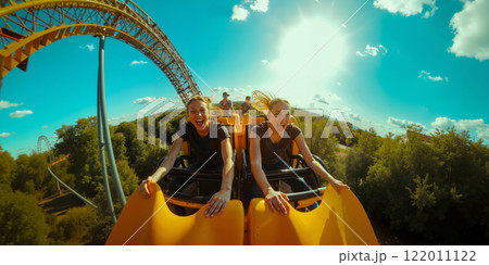 A couple of people riding a roller coaster at a theme park 122011122
