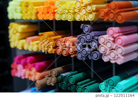 Vibrant collection of markers displayed on an organized shelf 122011164