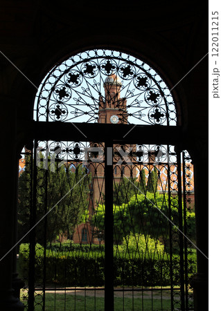 The church with the clock on the tower is visible through the closed door of the patio The church with the clock on the tower is visible through the closed door of the patio 122011215