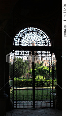 Forged lattice of the secret exit from the ancient castle and the temple chapel behind it Forged lattice of the secret exit from the ancient castle and the temple chapel behind it 122011216