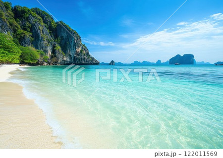 Scenic tropical beach with crystal clear blue waters and white sandy shores. 122011569