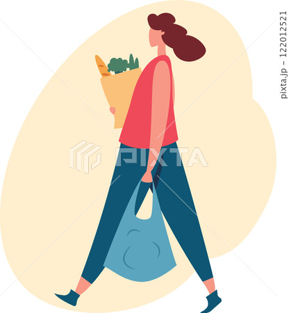 Happy customer is walking home after shopping for groceries at the local market, carrying fresh vegetables and bread in a paper bag and a reusable shopping bag 122012521