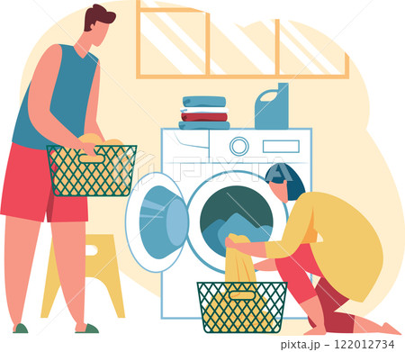 Man carrying basket full of dirty clothes and woman loading washing machine with laundry in the laundry room, performing daily household chores 122012734