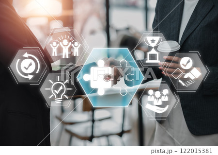 Visual representation of teamwork and collaboration with puzzle pieces and handshake, symbolizing partnership and success. 122015381