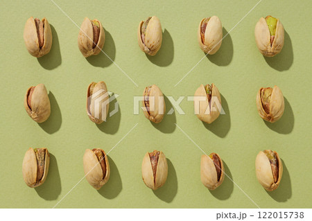 Pistachios, on a green background, top view. 122015738