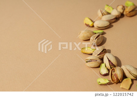 Pistachios in a plate, on a beige background. Pistachios in a plate, on a beige background. 122015742