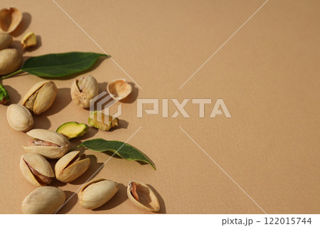 Pistachios in a plate, on a beige background. Pistachios in a plate, on a beige background. 122015744