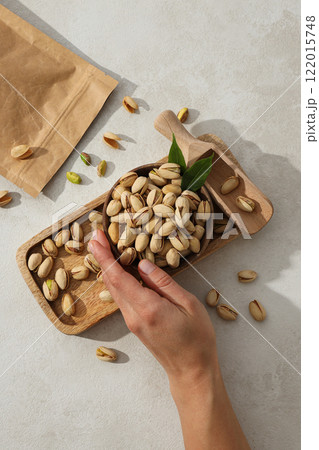 Pistachios in a craft bag, on a yellow background. Pistachios in a craft bag, on a yellow background. 122015748