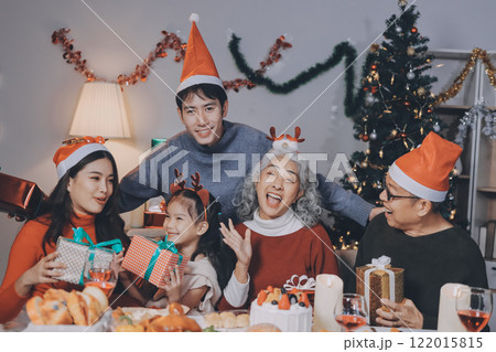 Happy family with gifts celebrating Christmas together 122015815