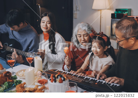 Multi-Generation Family Celebrate Christmas At Home Wearing Santa Hats And Antlers Opening Presents Multi-Generation Family Celebrate Christmas At Home Wearing Santa Hats And Antlers Opening Presents 122015832