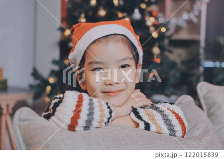 christmas, x-mas, winter, happiness concept - dreaming girl in santa helper hat 122015839
