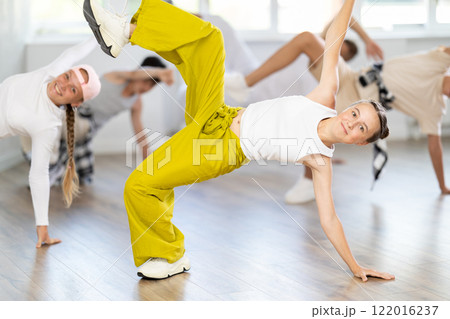 Teen girl with group of teenage friends, learn to dance hip hop 122016237