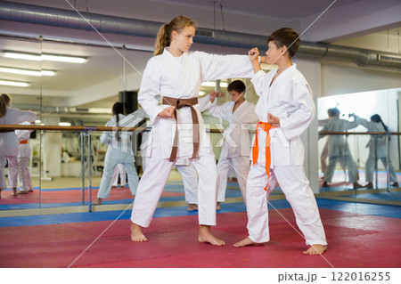 Teenager children practicing new self defense moves 122016255