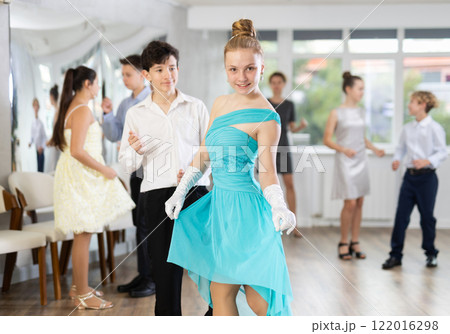 Elegant teenage girl and boy curtseying and bowing after dance performance Elegant teenage girl and boy curtseying and bowing after dance performance 122016298