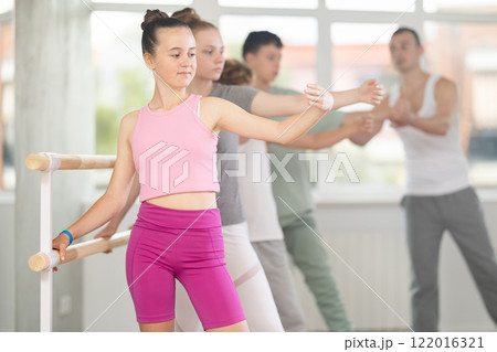 Teenage girl practicing ballet positions in dance studio Teenage girl practicing ballet positions in dance studio 122016321