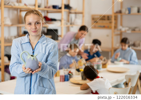 Teenage girl standing in art studio 122016334