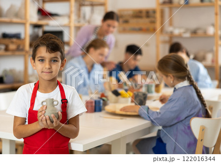 Little boy standing in art studio Little boy standing in art studio 122016344