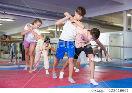 Kids learning self-defence moves in gym Kids learning self-defence moves in gym 122016661