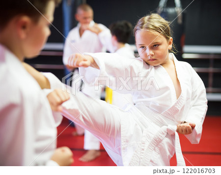 Kids sparring during karate training 122016703