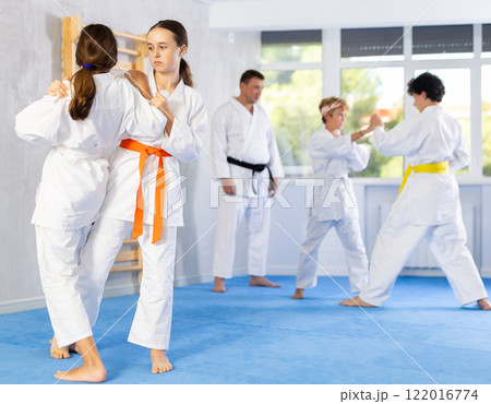 Two girls training judo techniques in studio Two girls training judo techniques in studio 122016774