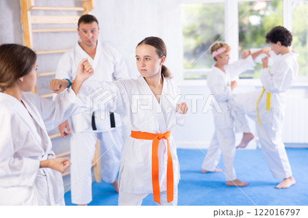 Young pupils train to perform defensive karate installations and attacking combat techniques Young pupils train to perform defensive karate installations and attacking combat techniques 122016797