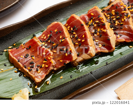 Popular Japanese dish Tataki from tuna with an appetizing ponzu sauce 122016841
